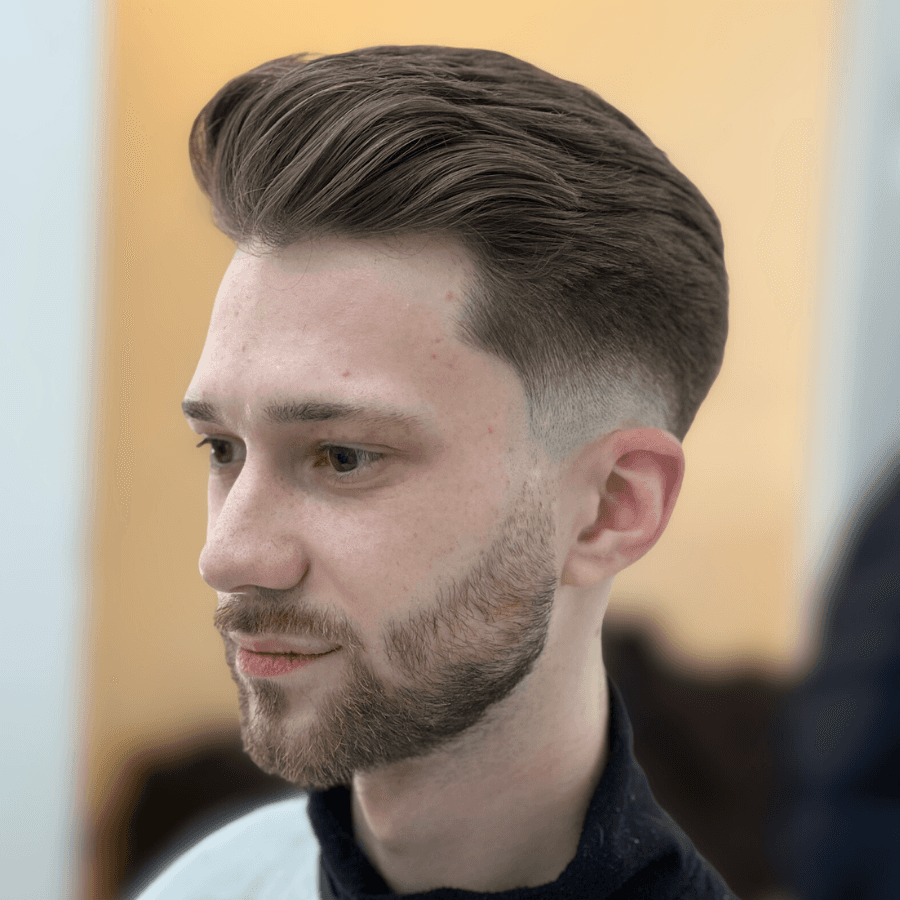 person holding white and gold hair comb