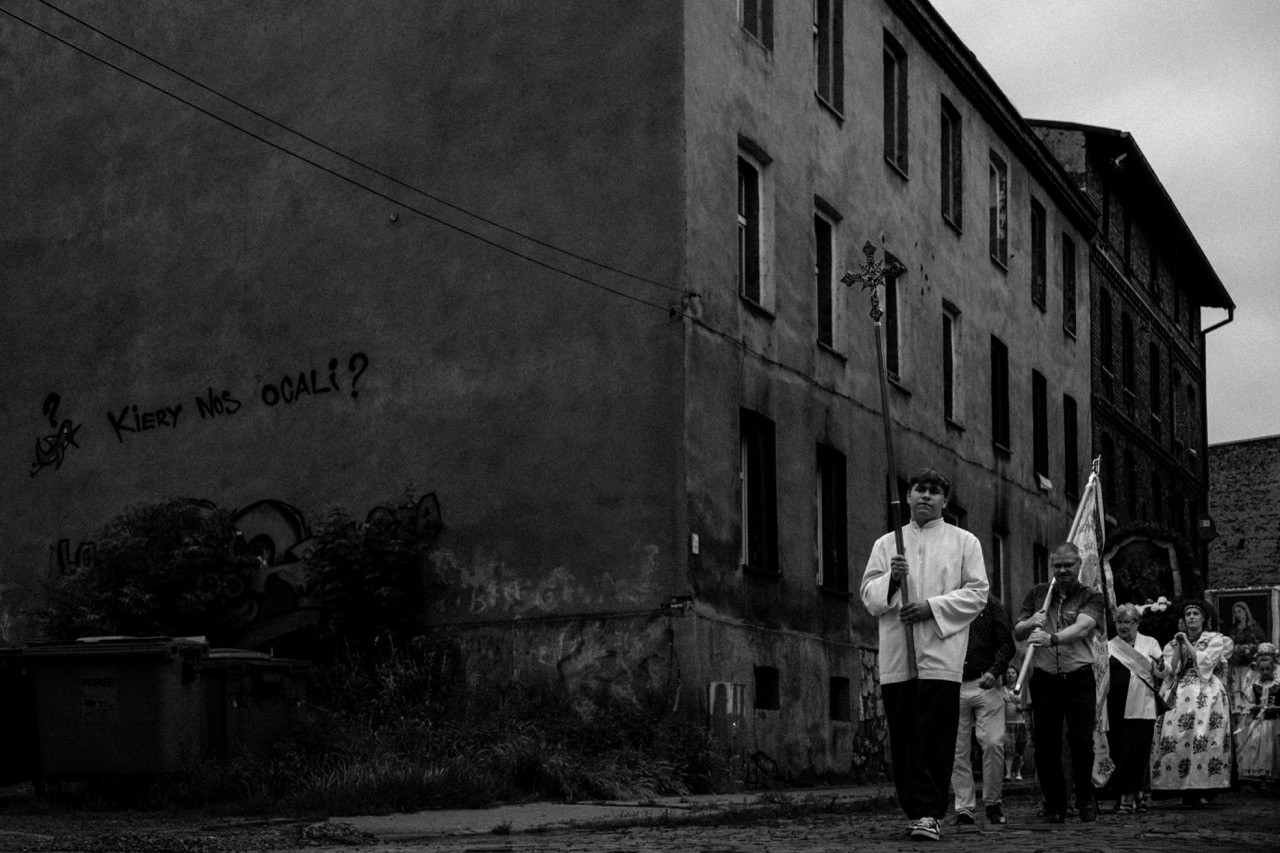 Crowd of people participating in a religious celebration in Poland, black and white reportage.