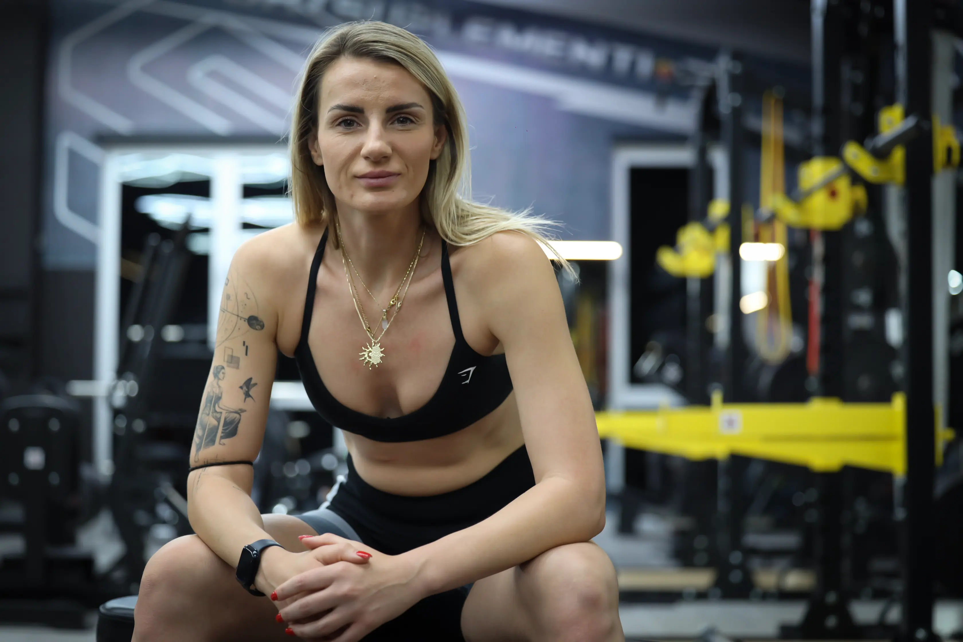 woman wearing black sports bra facing front selective focus photography