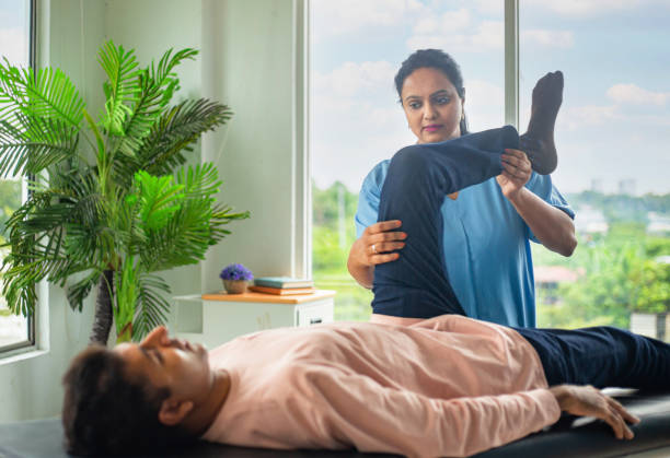 Physiotherapist performing knee flexion therapy to improve lower-limb mobility and reduce knee pain.