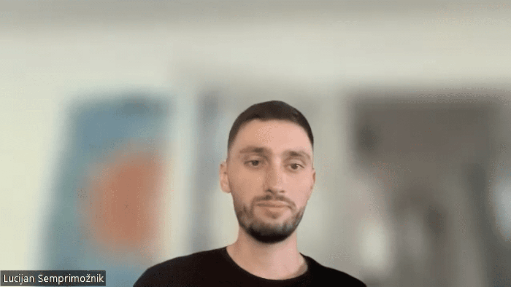 Man and woman working side by side at a desk, both focused on their laptops.
