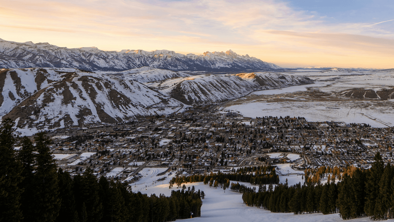 Aerial view of Jackson Hole valley and Snake River with Teton mountains at sunset representing where Bootpack Financial clients live and thrive