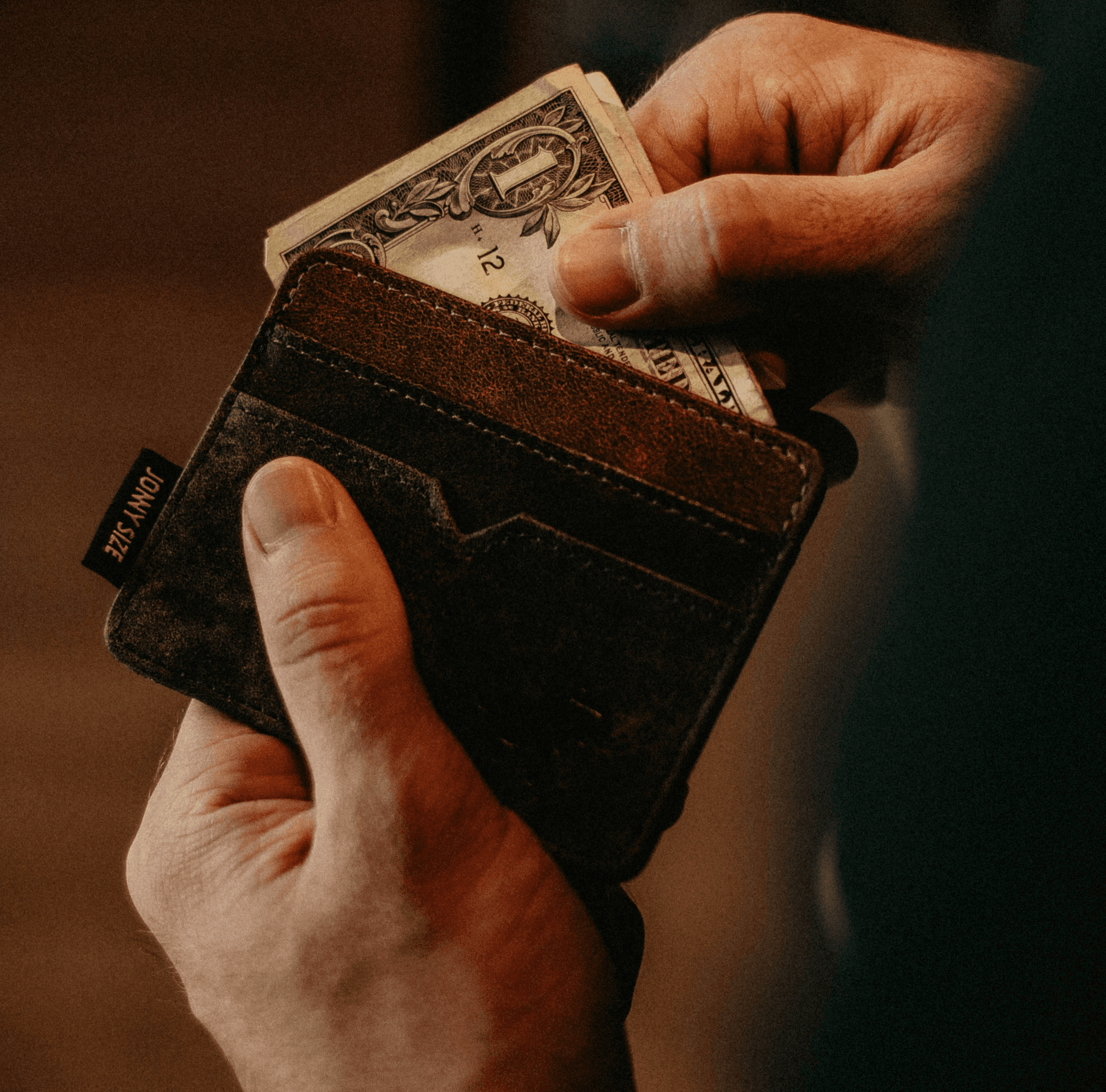 leather wallet with cash, representing the financial history and evolution of anesthesia subsidy models