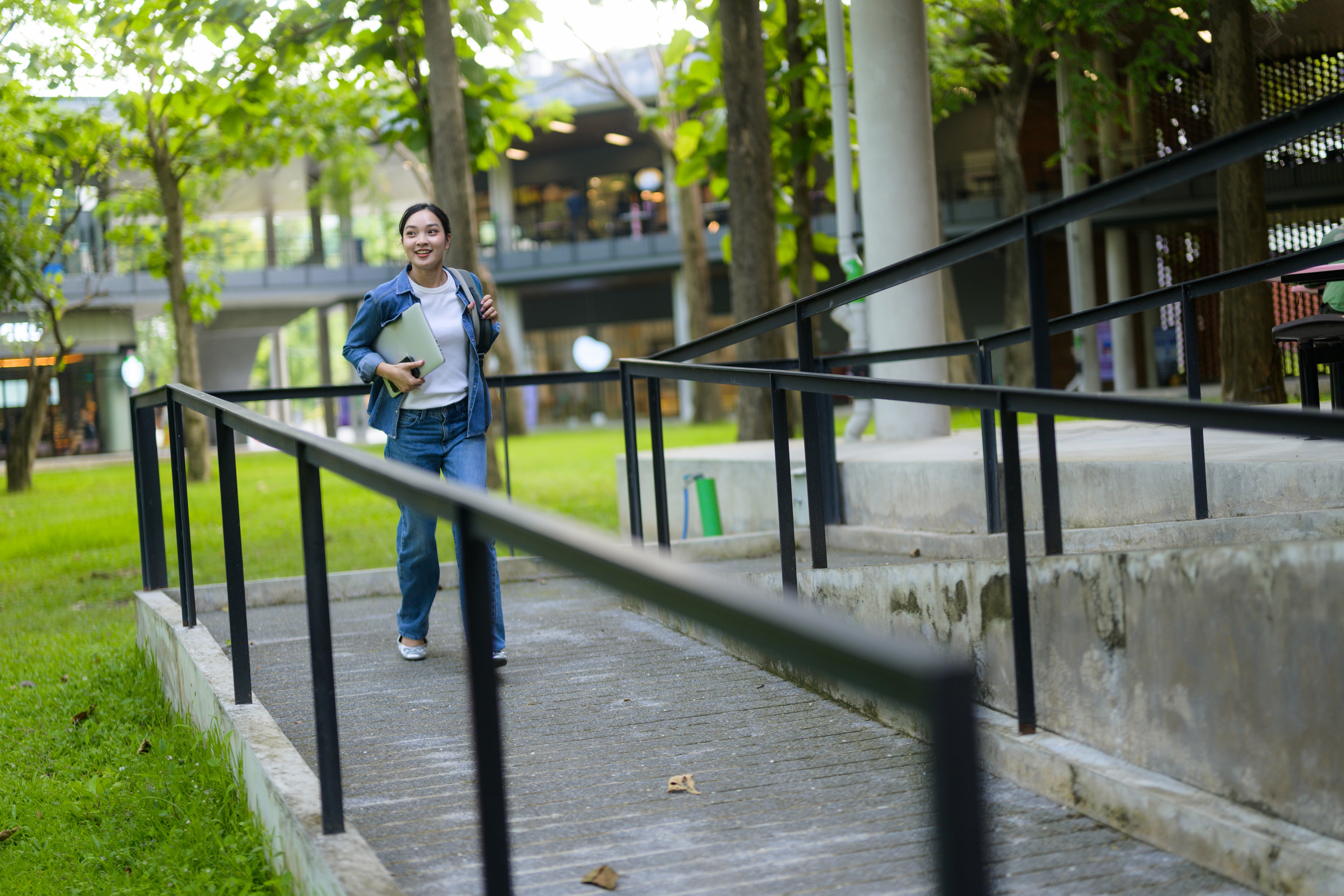 A woman walking on the wheelchair ramp
