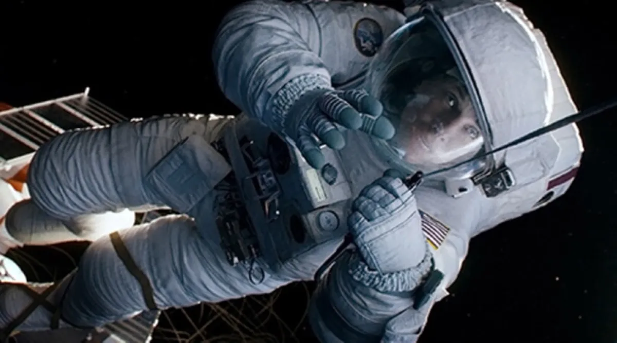 An astronaut in a white spacesuit floats in the vastness of outer space, with a satellite in the background, highlighting the theme of space exploration.