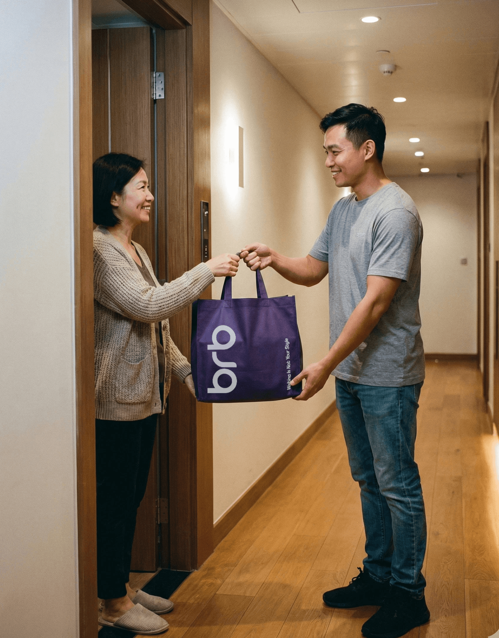 A rider handing a purple BRB bag to a smiling woman at the door of her apartment hallway