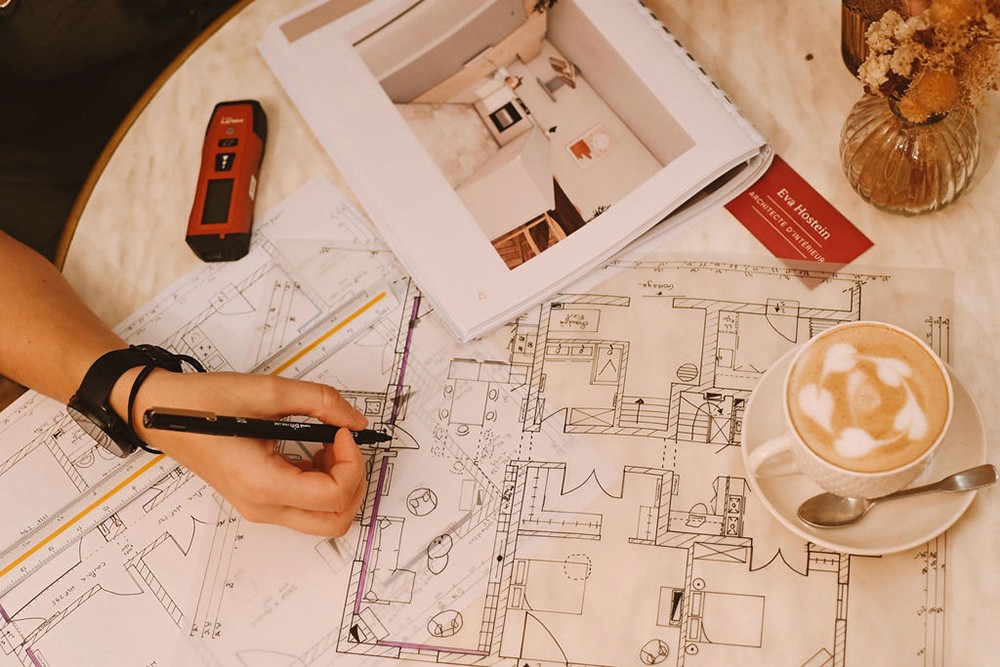 Eva Hostein architecte d'intérieur annotant un plan d'aménagement pour un dossier ERP – local professionnel à Bordeaux, Gironde