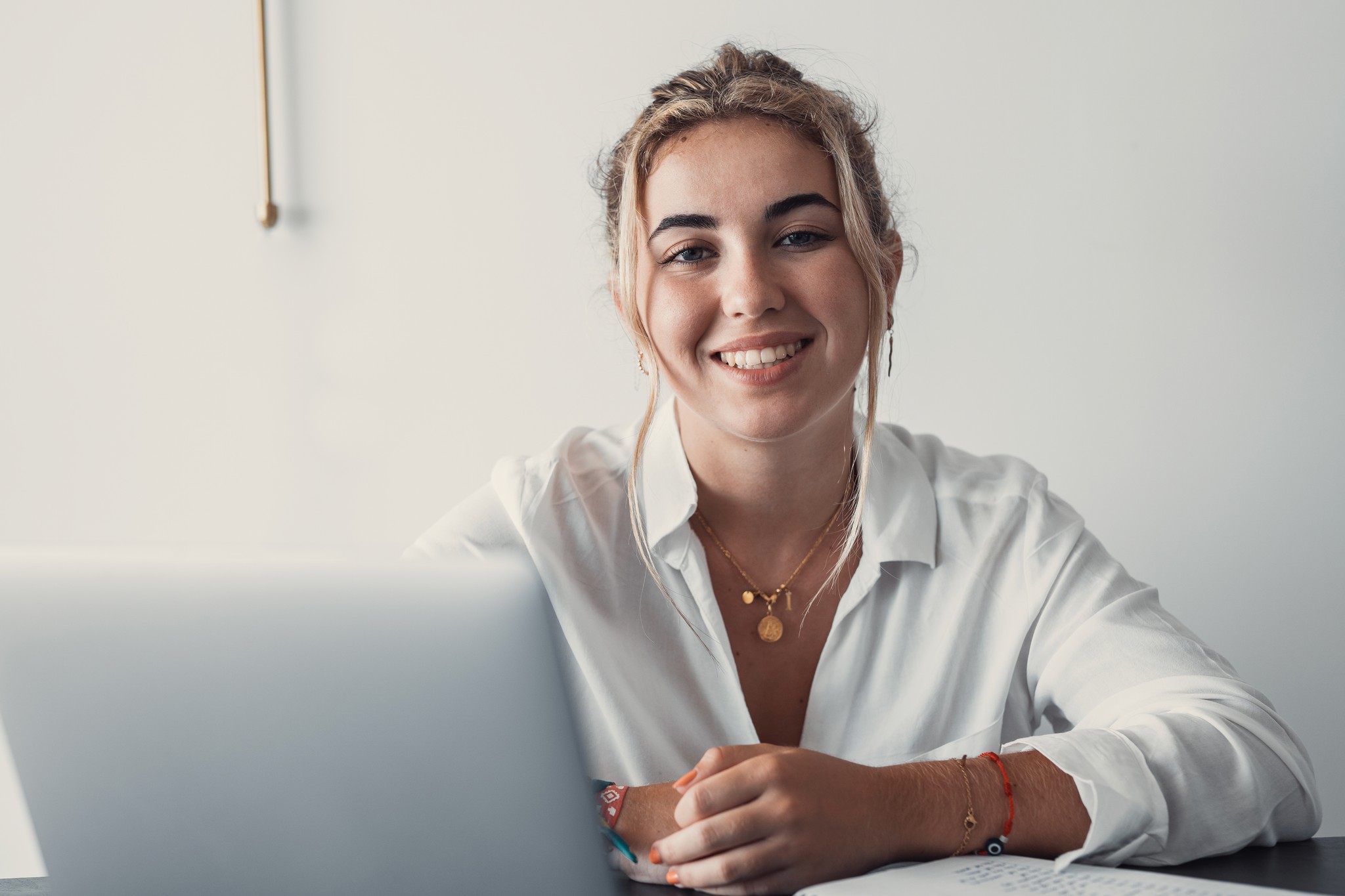 Smiling professional at her laptop in a bright workspace