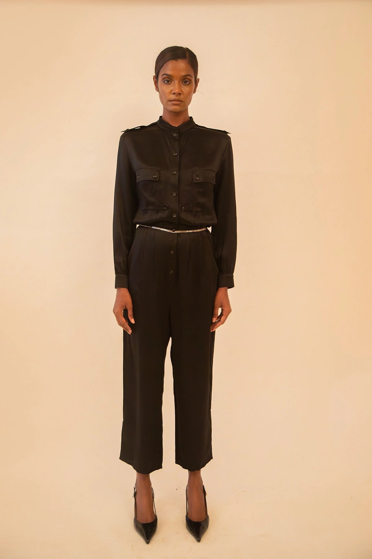 Vintage YSL black button-up jumpsuit featuring a tailored fit and classic detailing, sourced from global designer archives.