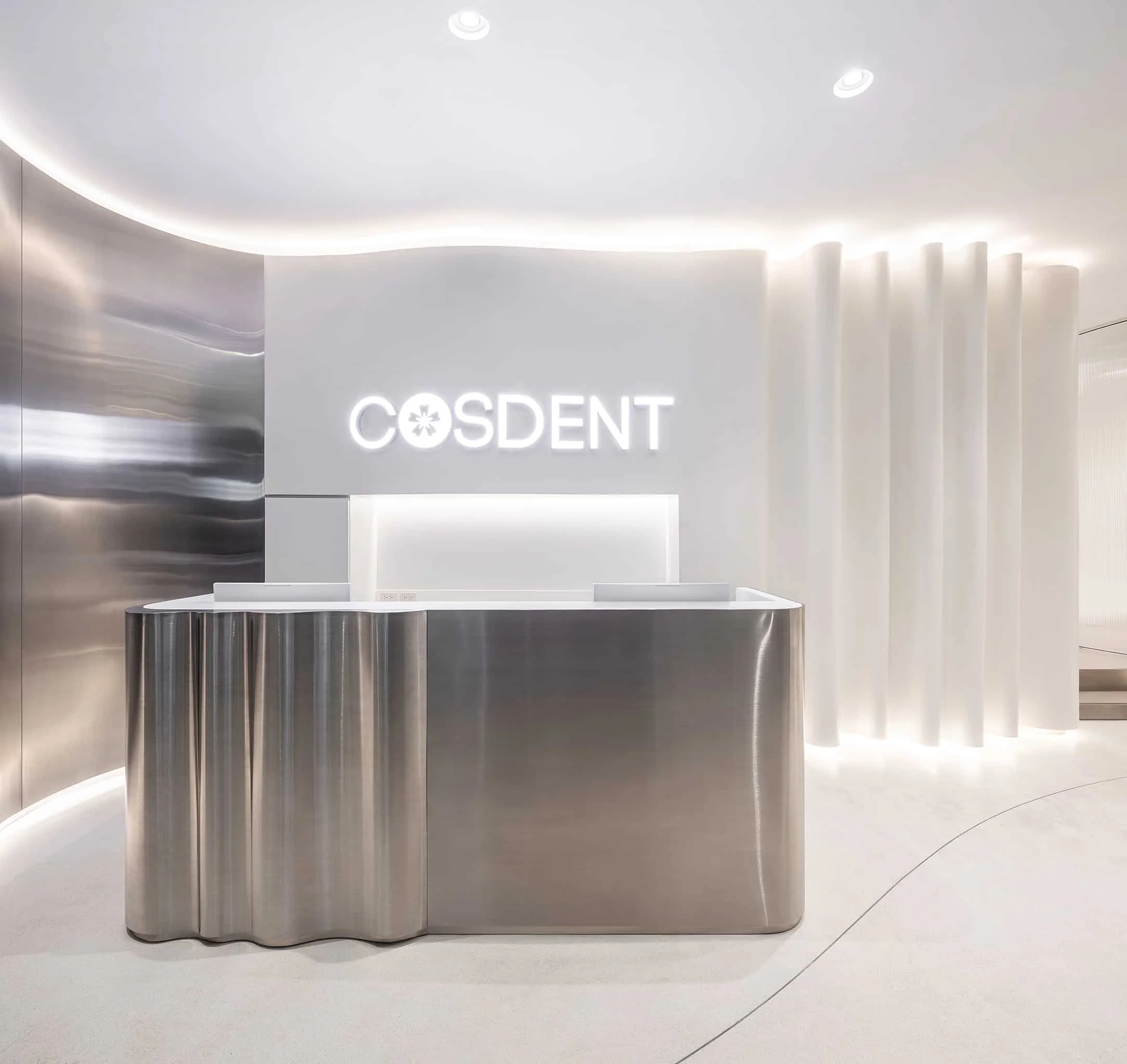 Illuminated reception desk with the COSDENT sign at Siam Square One
