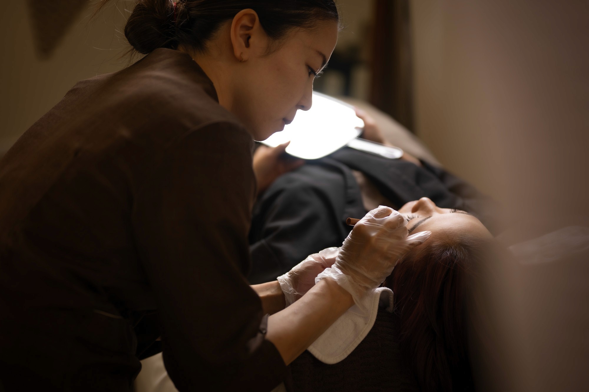 En Beauty salon photography by Kyttn. Izumi applying brow treatment.