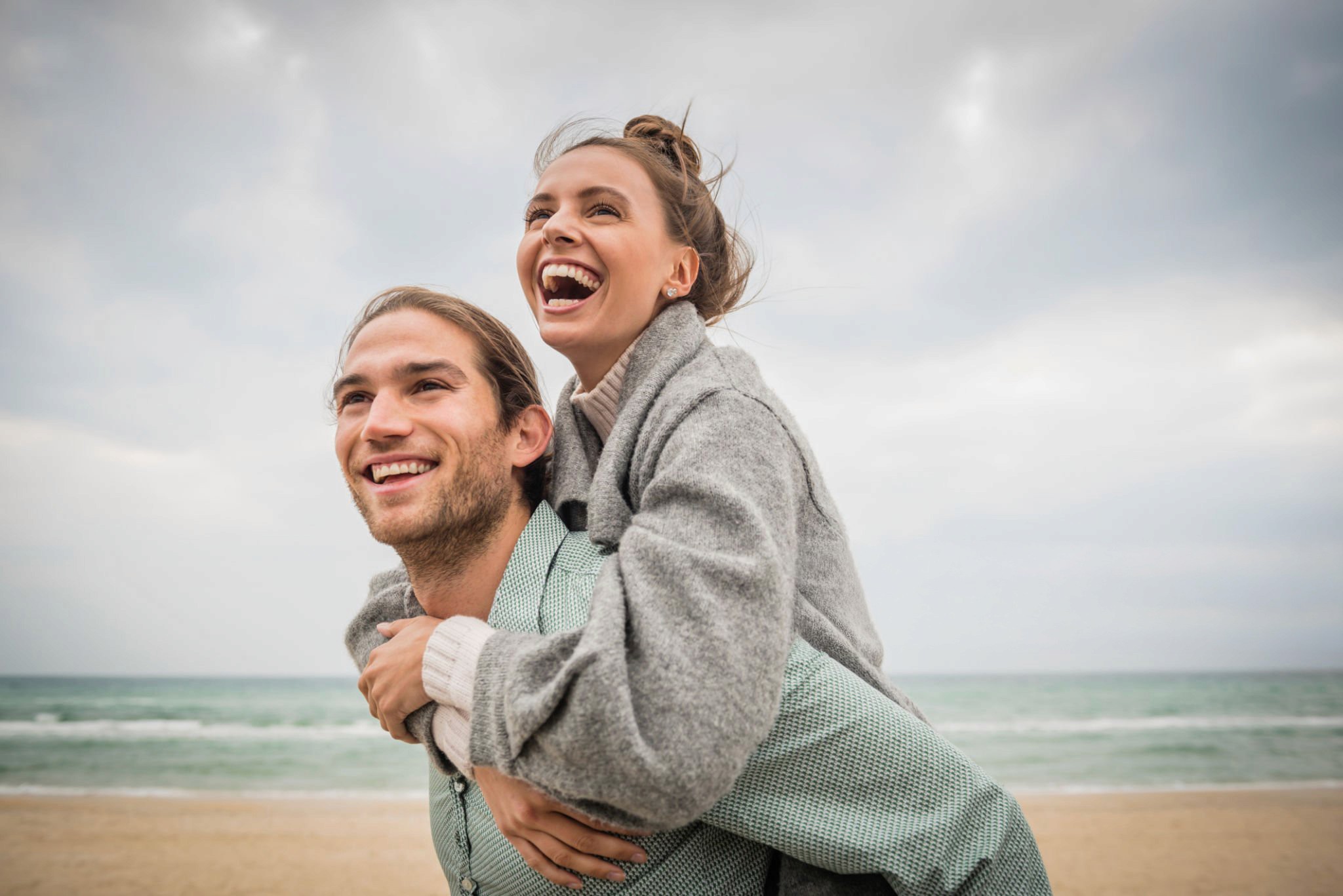 Woman holding a smartphone looking through the glass 