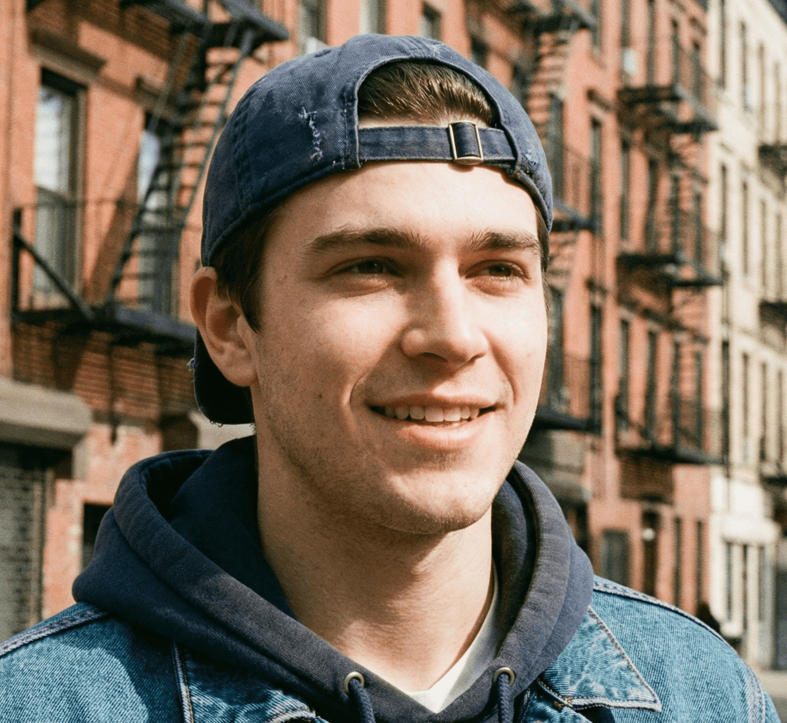 young man on cap smiling