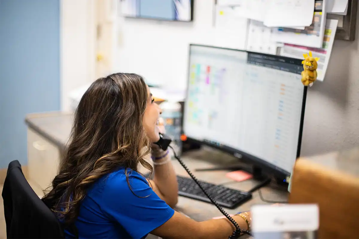 Veterinary CSR happily chatting on the phone