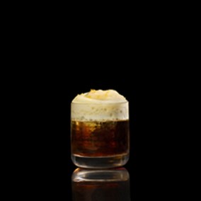 A closeup of a The Barr Americano drink against a dark background.