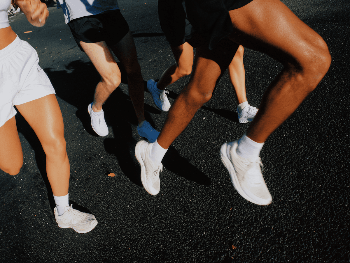 Runners legs in motion on asphalt. Running shoes and healthy legs.
