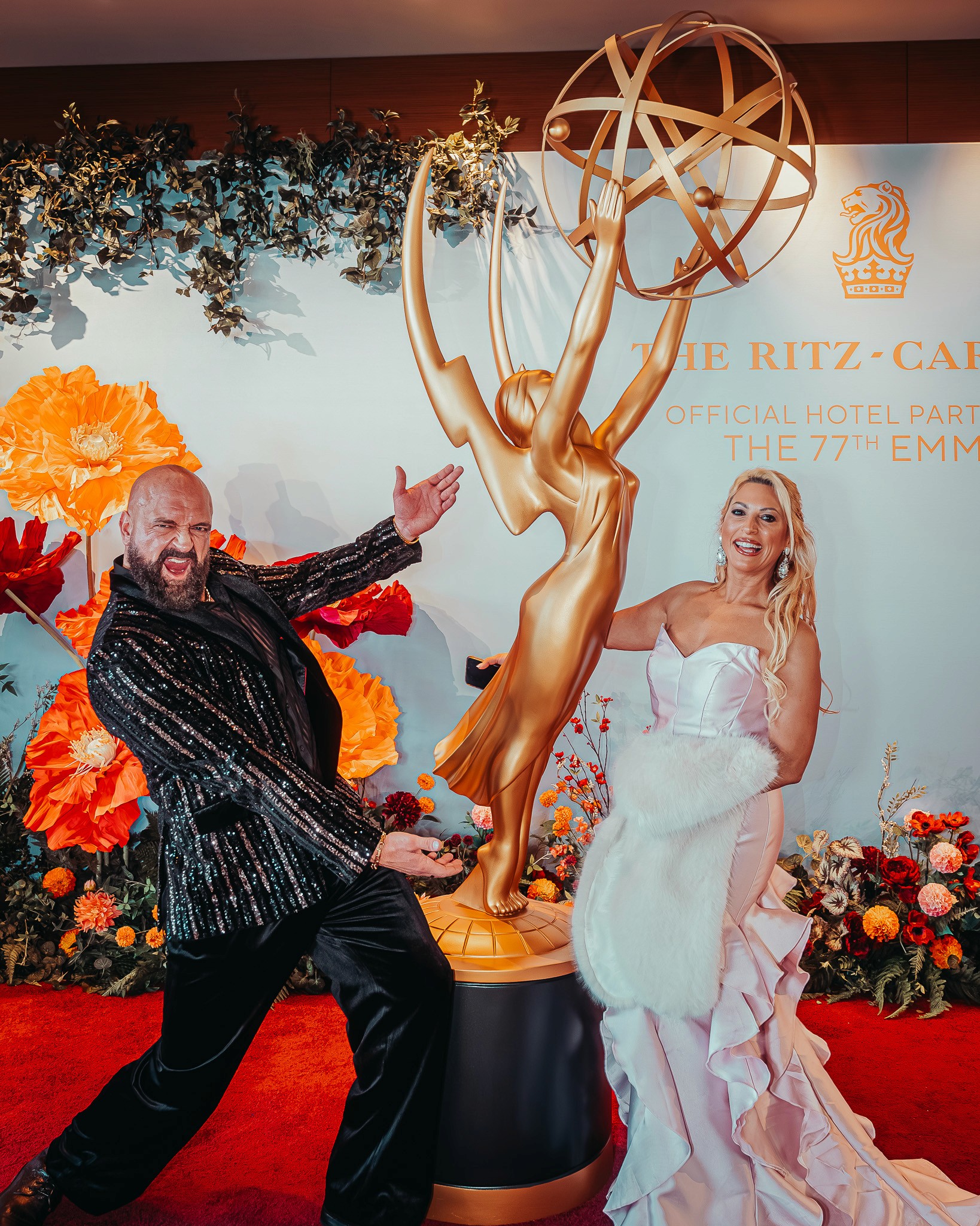 Landon Brittain attending the 77th Emmy Awards in black sequin Barabas Men jacket.
