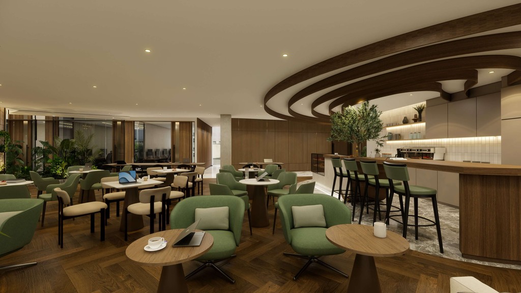 Relaxed lounge zone with soft green seating, round tables, and coffee bar in serviced offices dubai.