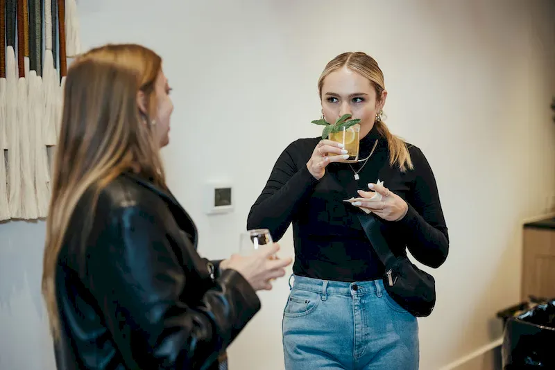 Girl drinking a cocktail at an event
