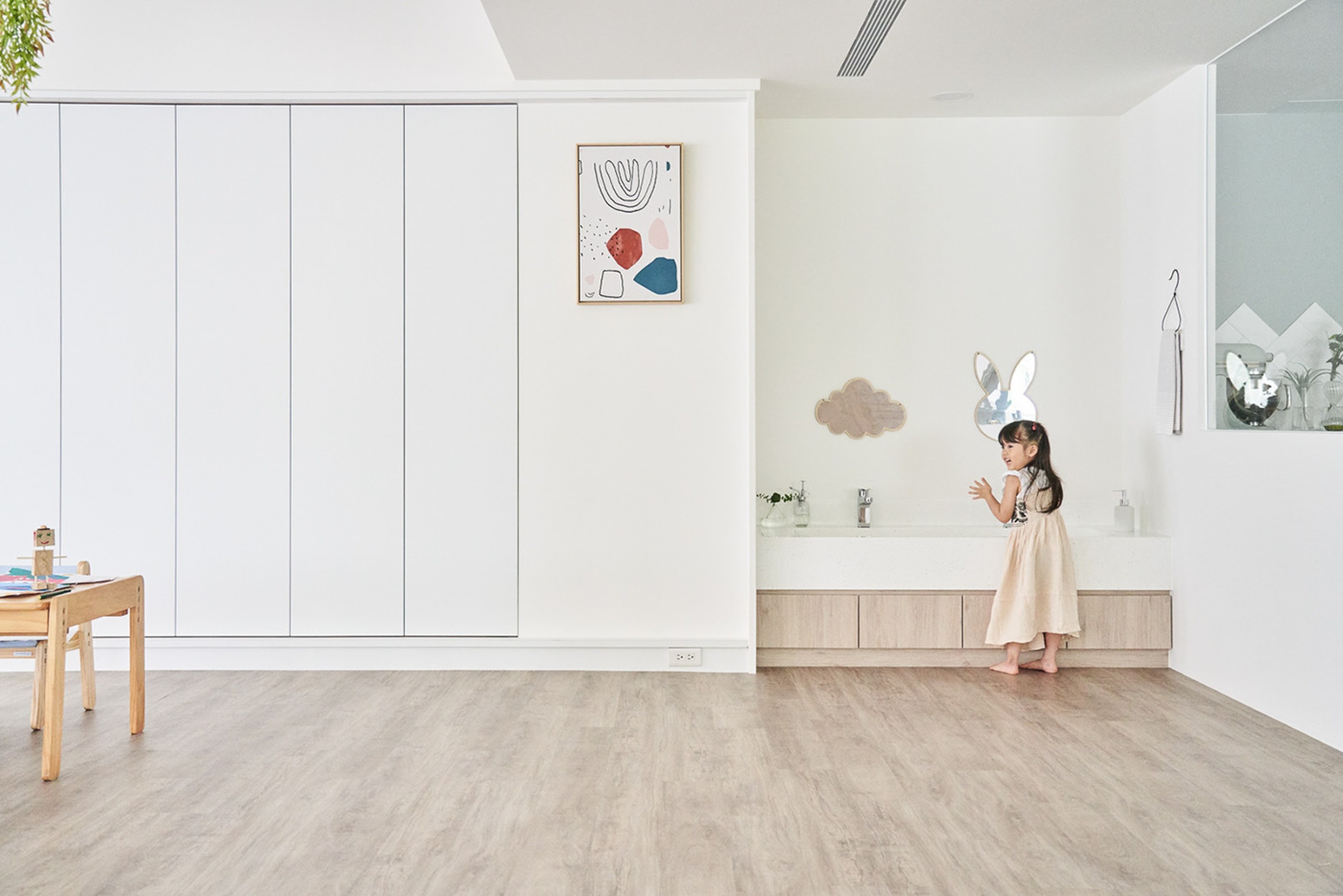 Bright, minimalist kids playroom in a Brisbane home, with easy-clean flooring that handles mess, movement, and everyday play without stress.