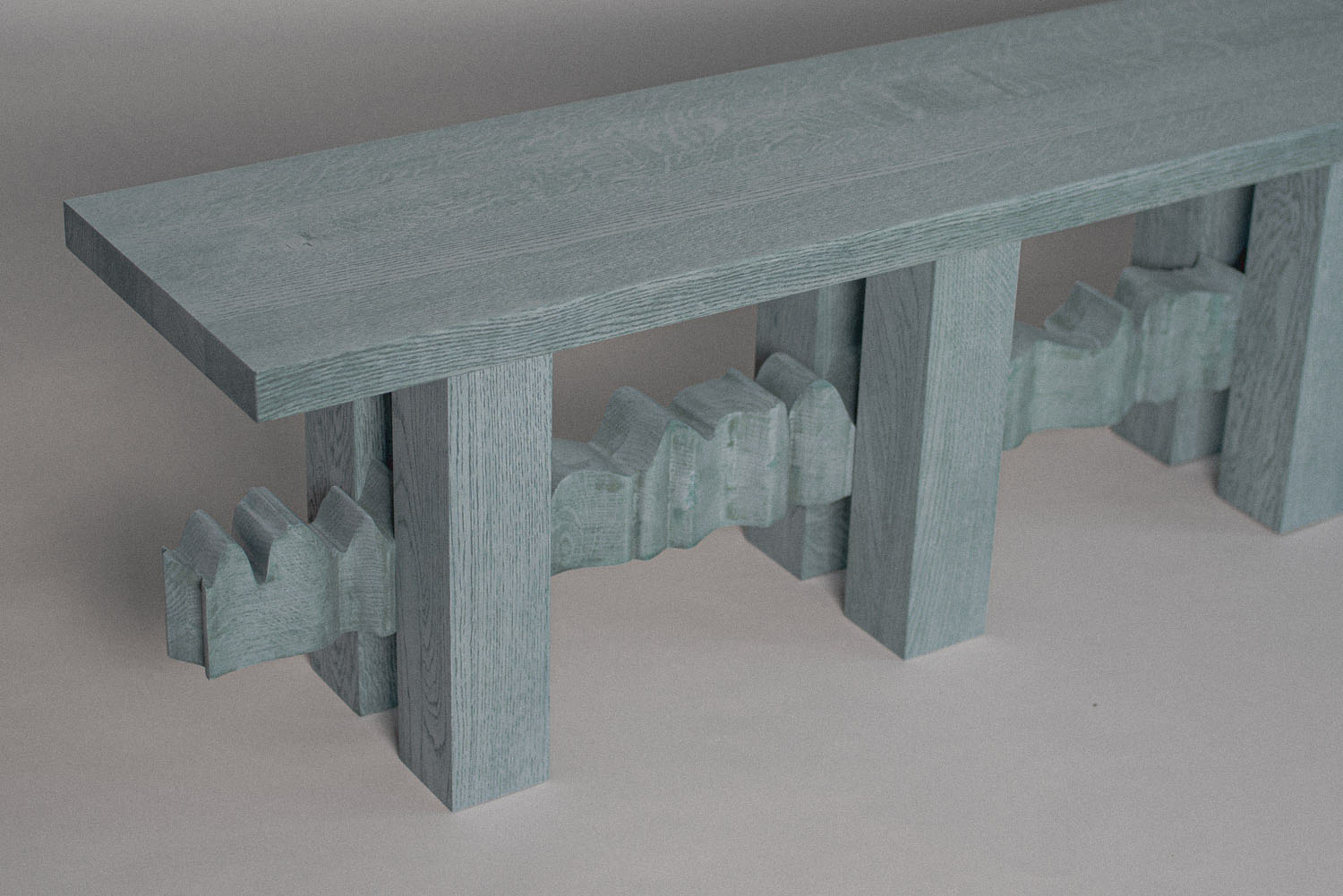 Close-up of YKB bench showing solid ash wood grain and refined surface finish by Jiri Krejcirik