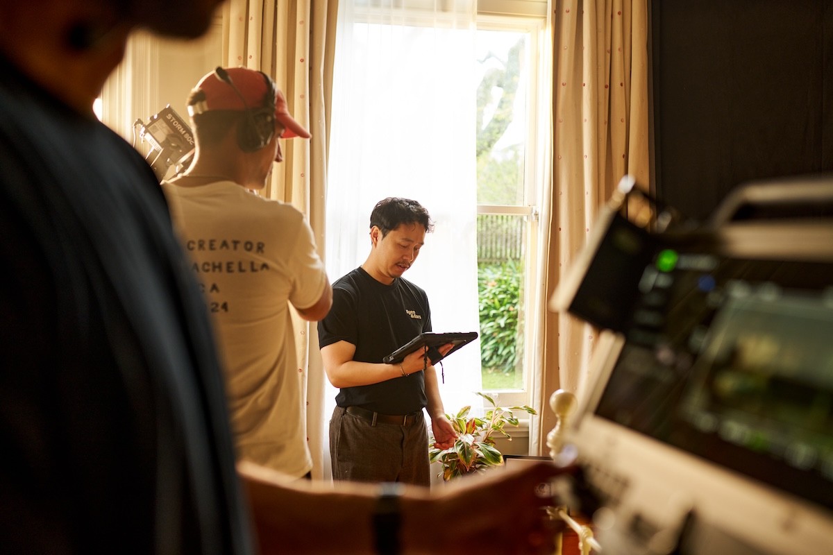 a man standing with an iPad on a film set