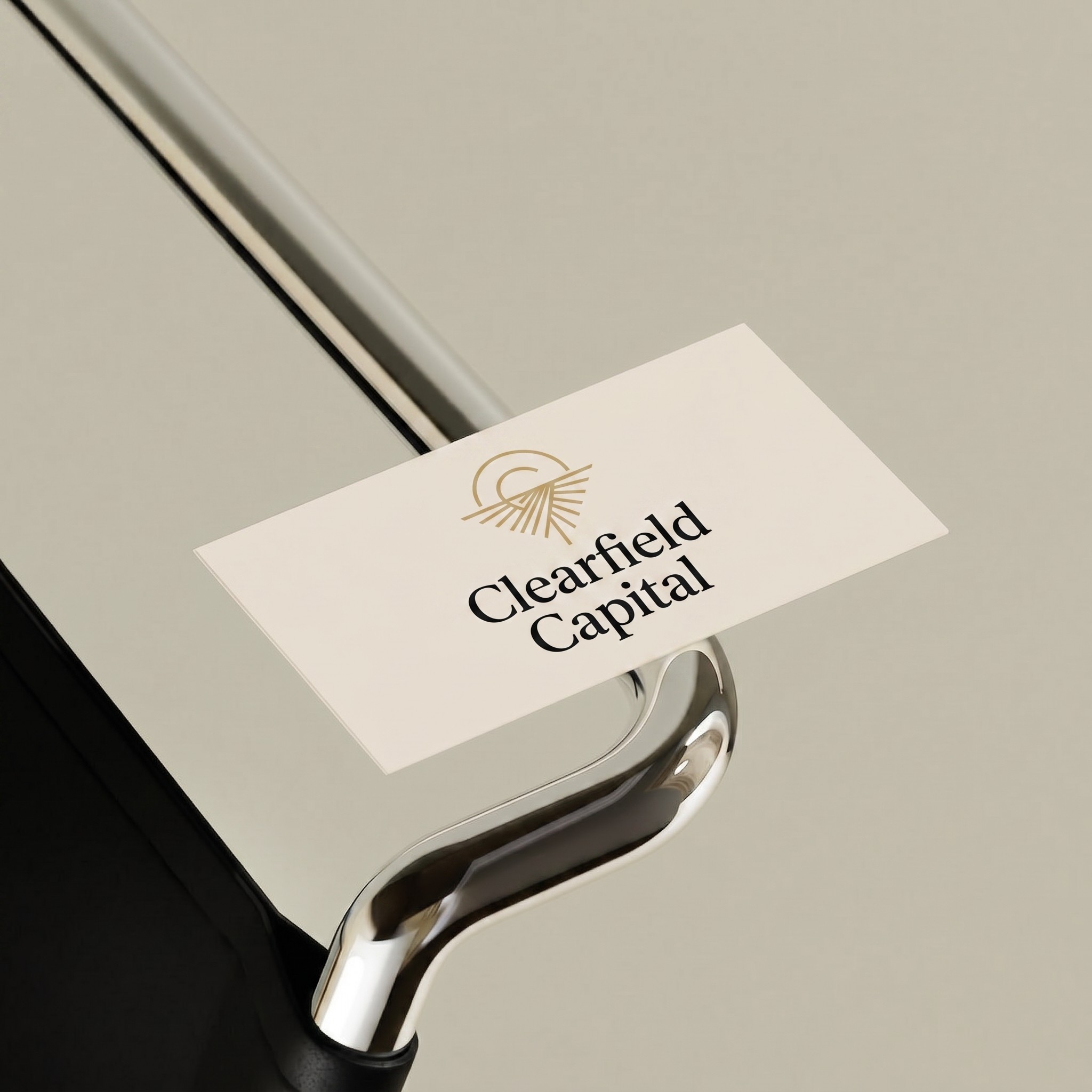 business card on a the metal handle of a chair