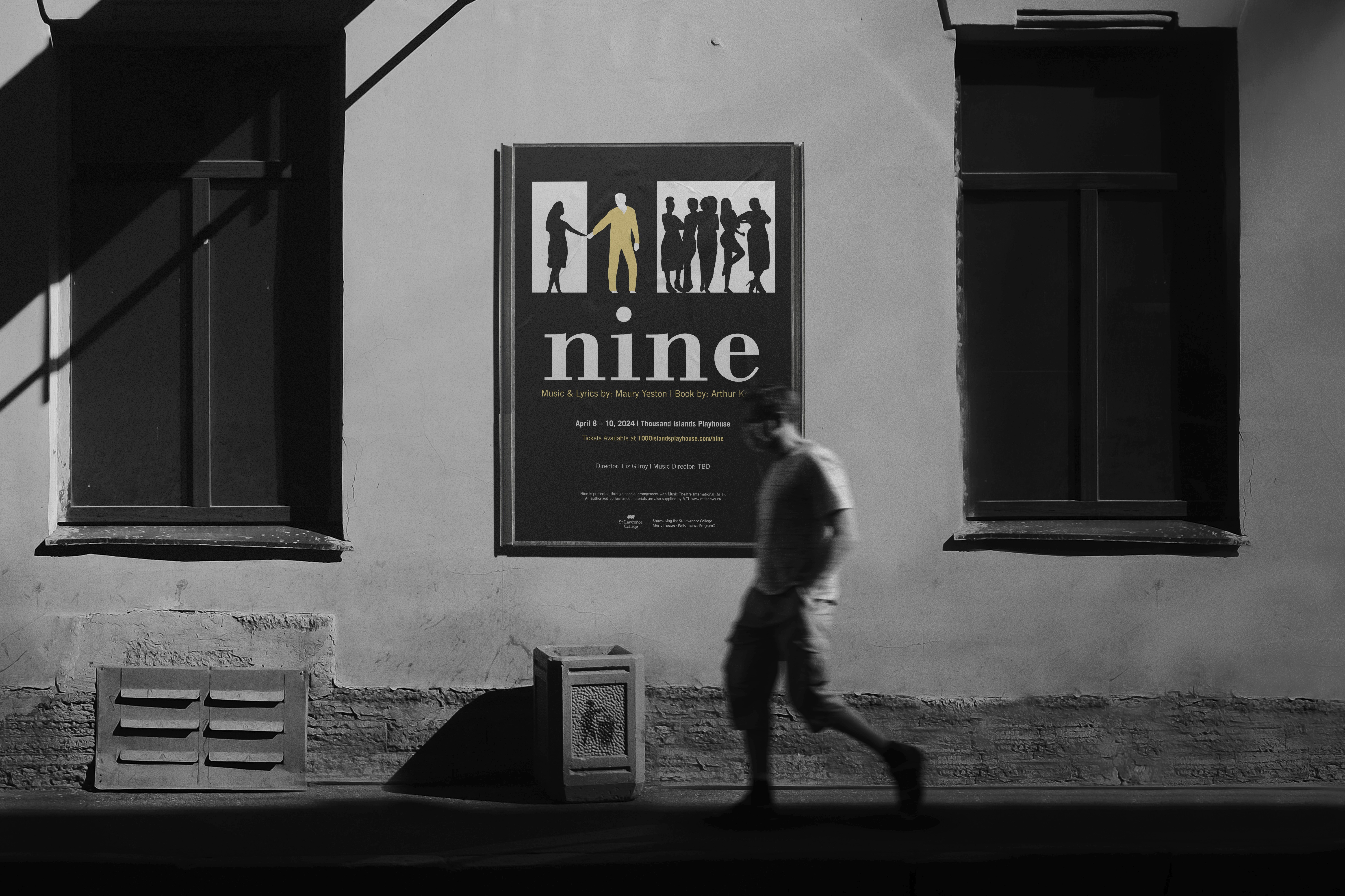 Mockup of the poster for Nine the musical hanging on a wall in black and white with a person walking in front.