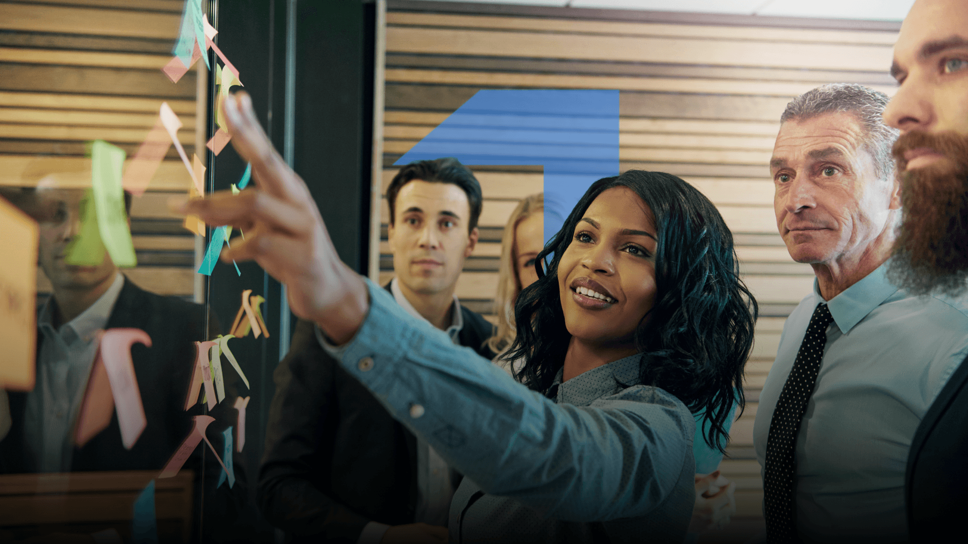 A group of people, including a smiling woman, in what appears to be a workplace setting, with the text "Building a high-performing team starts here" displayed prominently.