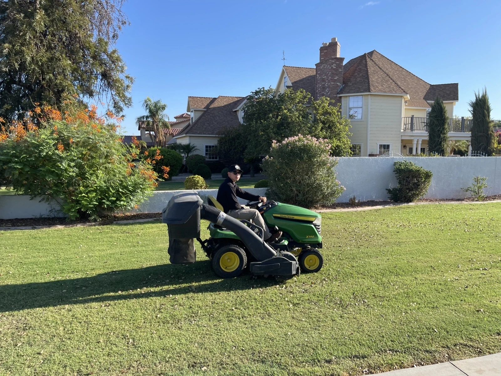 black and yellow push lawn mower on green grass during daytime