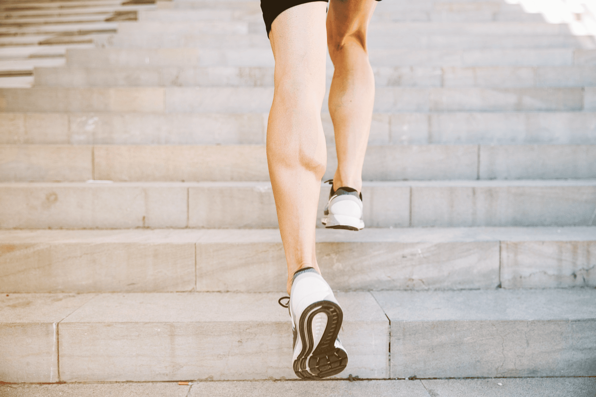 close up shot of legs walking up the stairs.