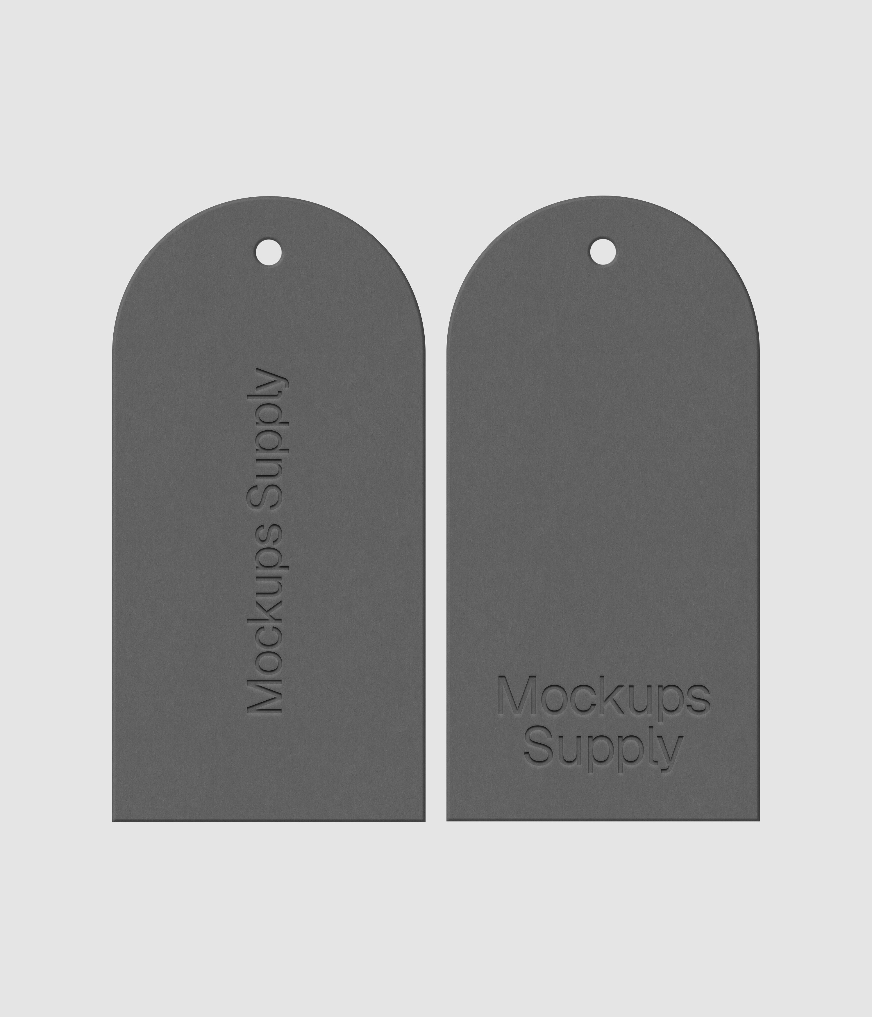 Pair of white arched top clothing tags featuring embossed branding on dark surface with customizable design for fashion collection mockup
