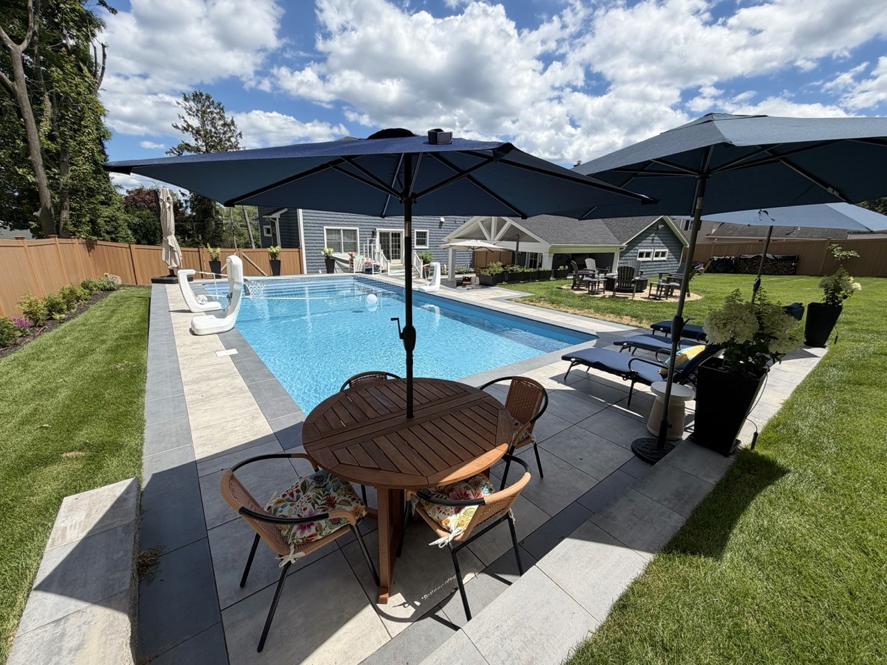 In-ground pool with paver patio and lounge area by CMC Masonry