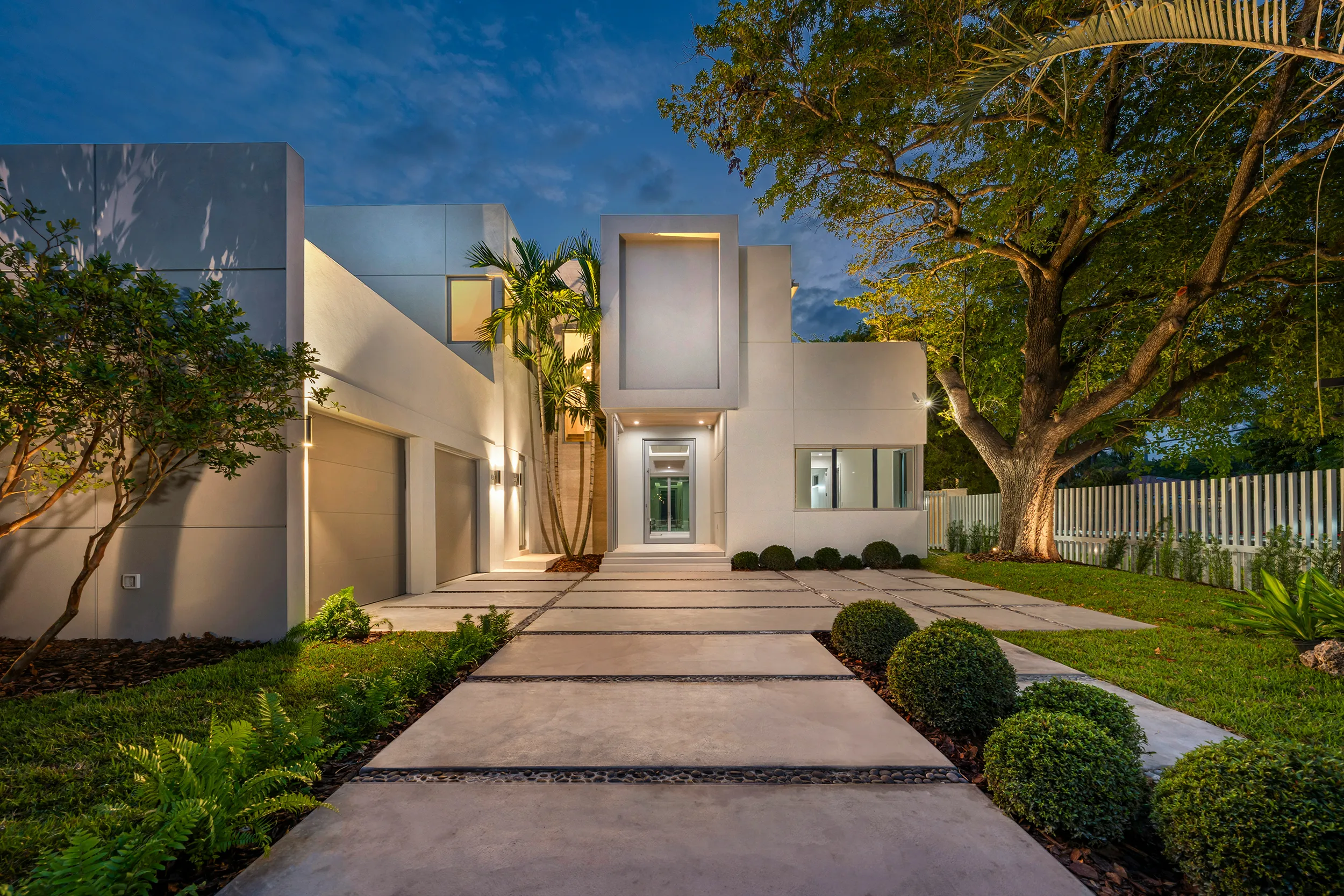 Contemporary luxury home with minimalist facade and landscaped entrance walkway