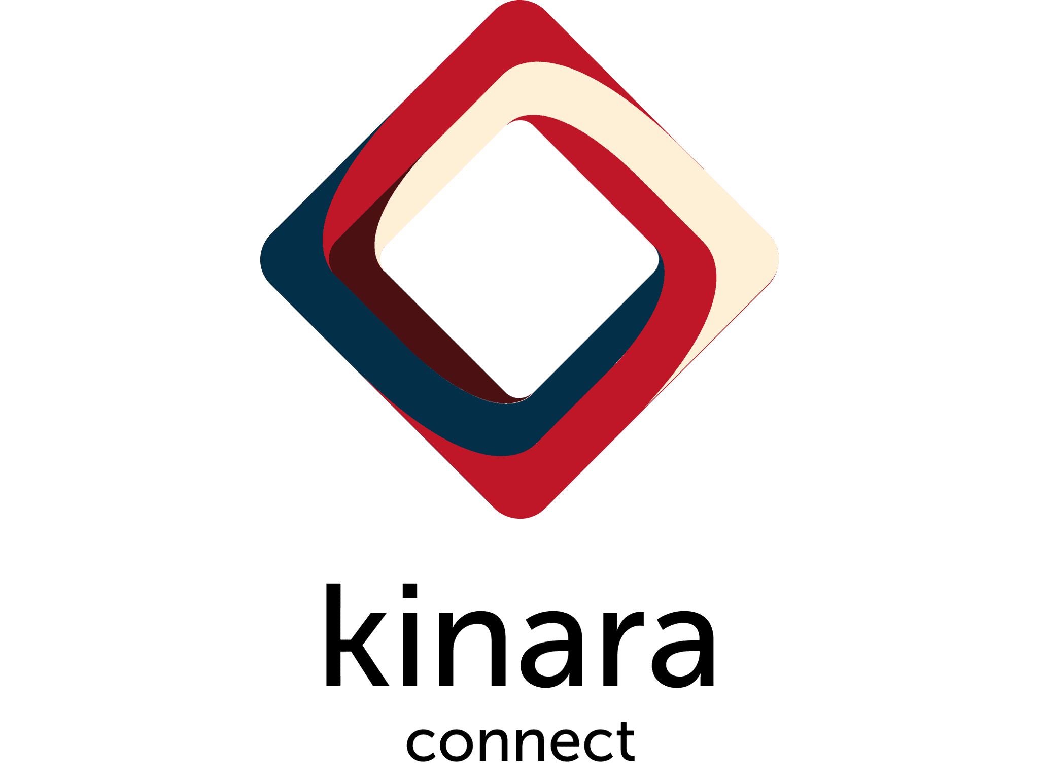 A young person with curly hair smiles at the camera while sitting in front of a laptop against a dark background.