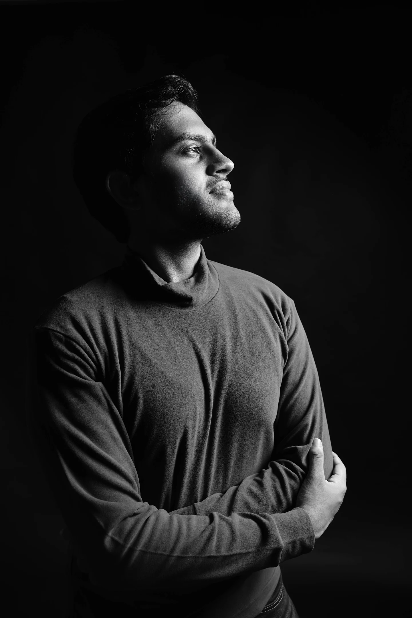 Black-and-white portrait of Naman Jain looking toward the light