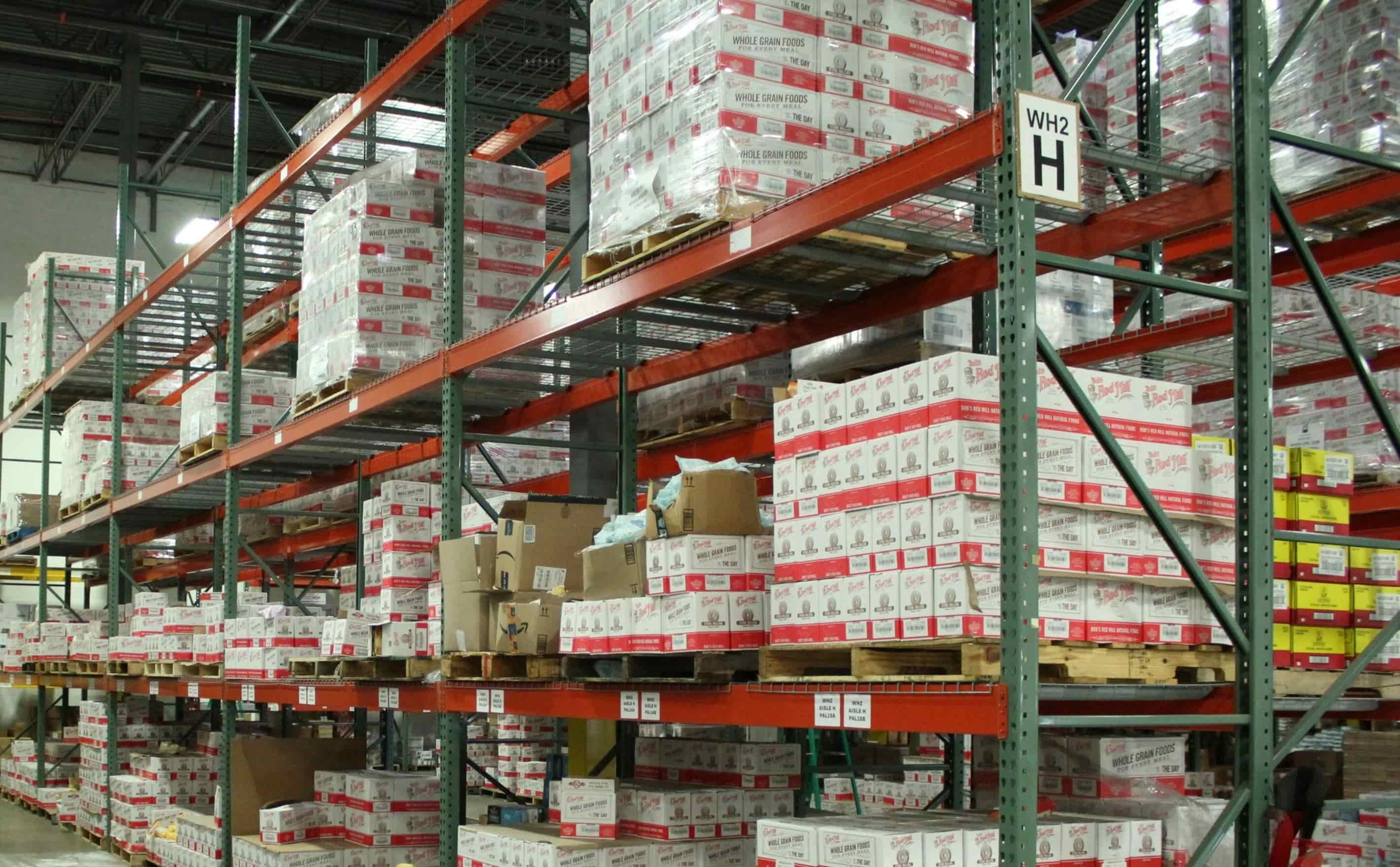 Warehouse inventory and pallet racking with packaged products, representing industrial distribution and supply chain operations