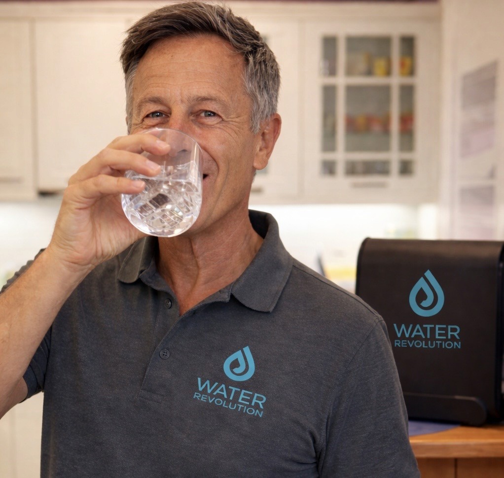 woman in white crew neck shirt drinking water