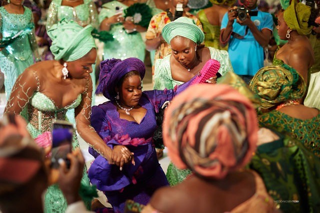 Groom and Bride happy with family and friends. Luxury wedding planned by Victoria Brooks Events in Nigeria with elegant décor and beautiful reception