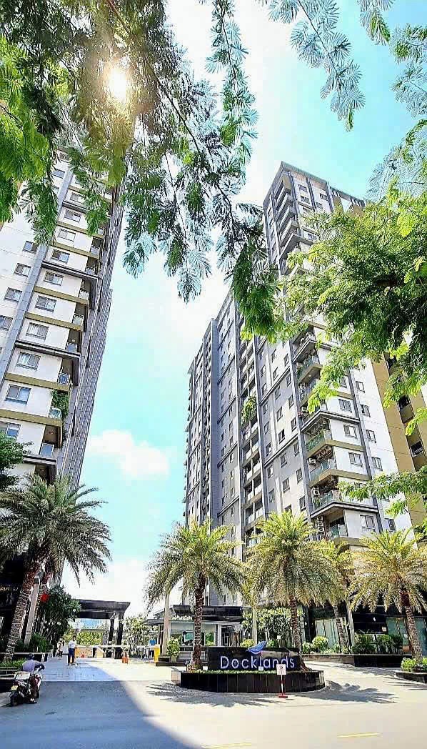 Modern villa exterior with sharp angular roof and large glass facade at sunset.