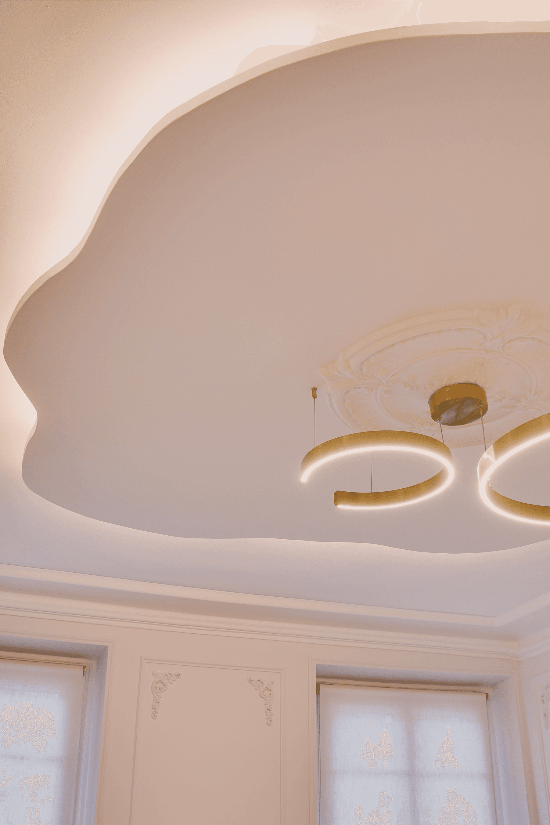 Close-up portrait of a woman with long red hair, closed eyes, and a soft expression, against a beige background