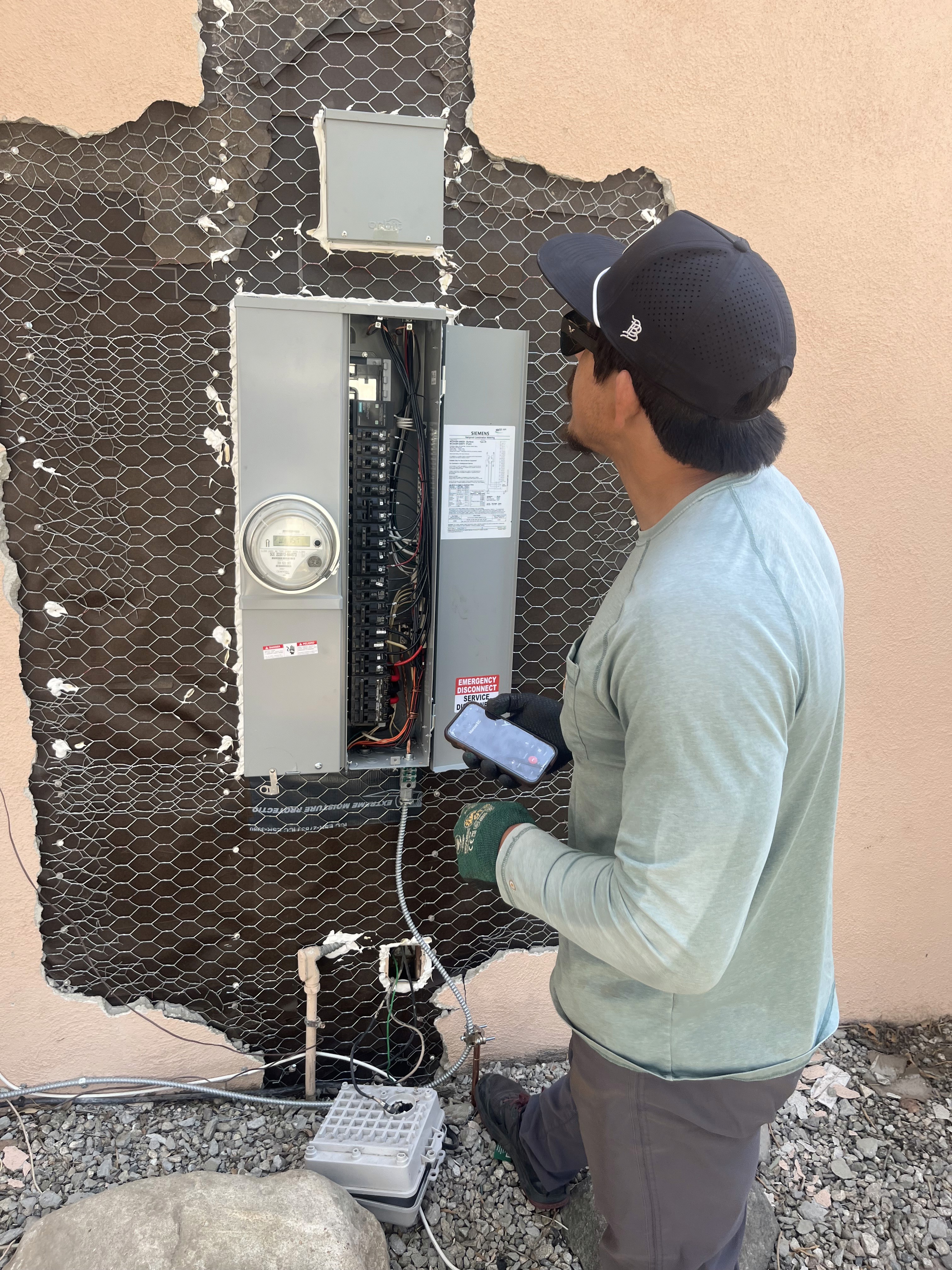 A man looking at an electrical box
