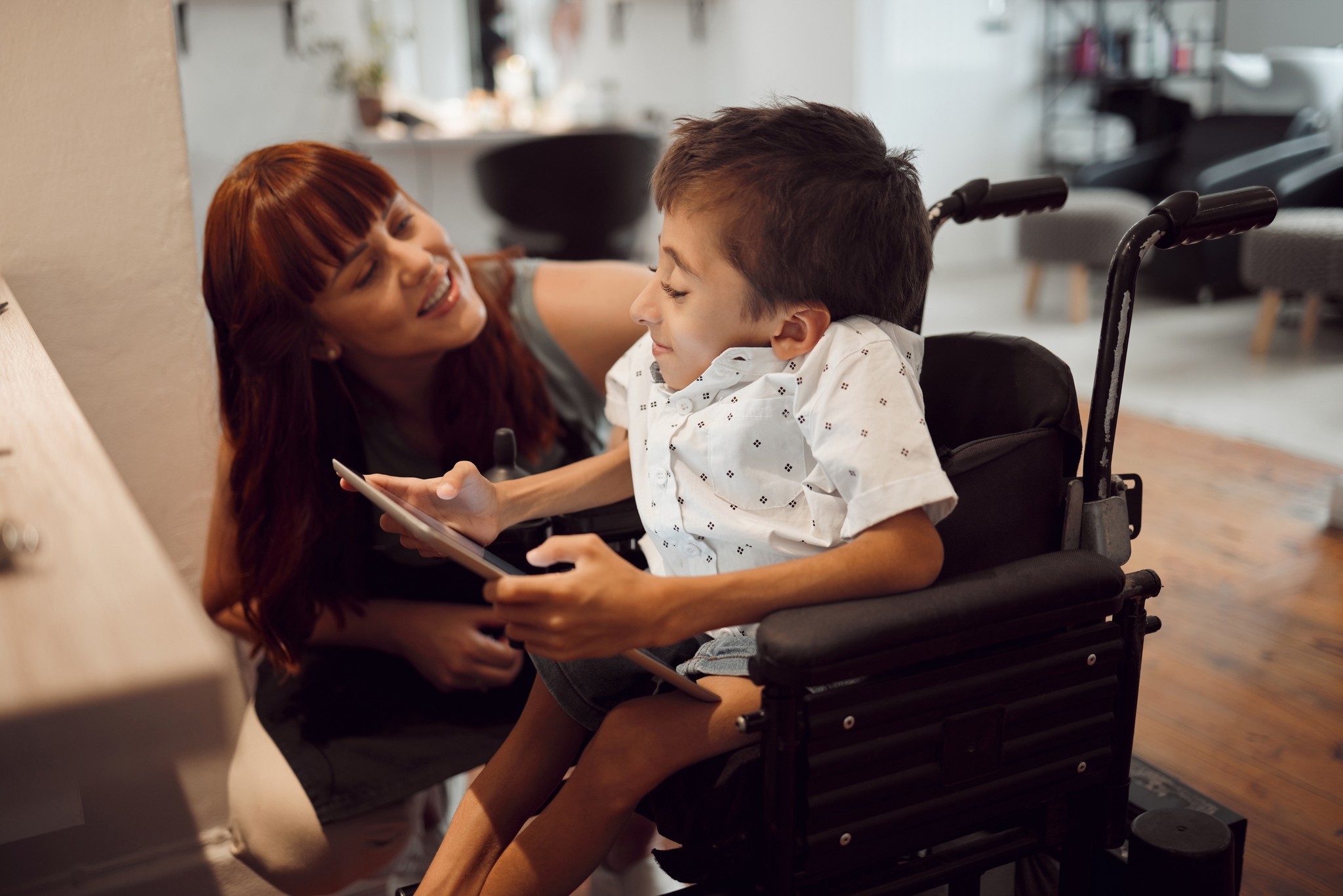 a woman is giving a boy a high five
