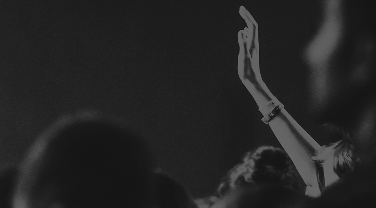 Crowd member raising a hand at a public event