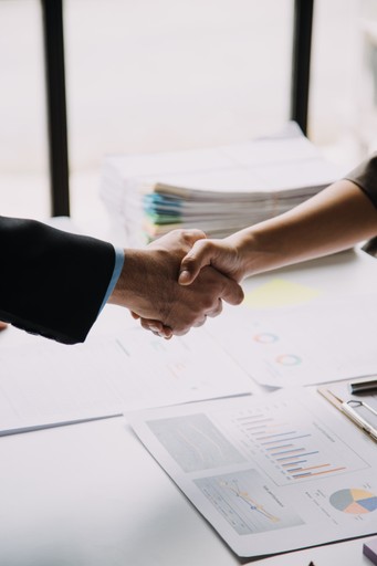 Closeup of business handshake symbolizing partnership, trust, and onboarding with EU compliance experts.