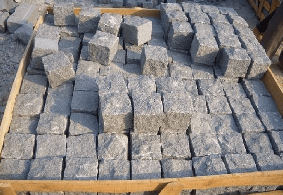 Pallet of split stone cubes crafted by the stone splitting machine, ready for use in paving projects and wall mosaics, illustrating the machine's efficiency in producing high-quality building materials.