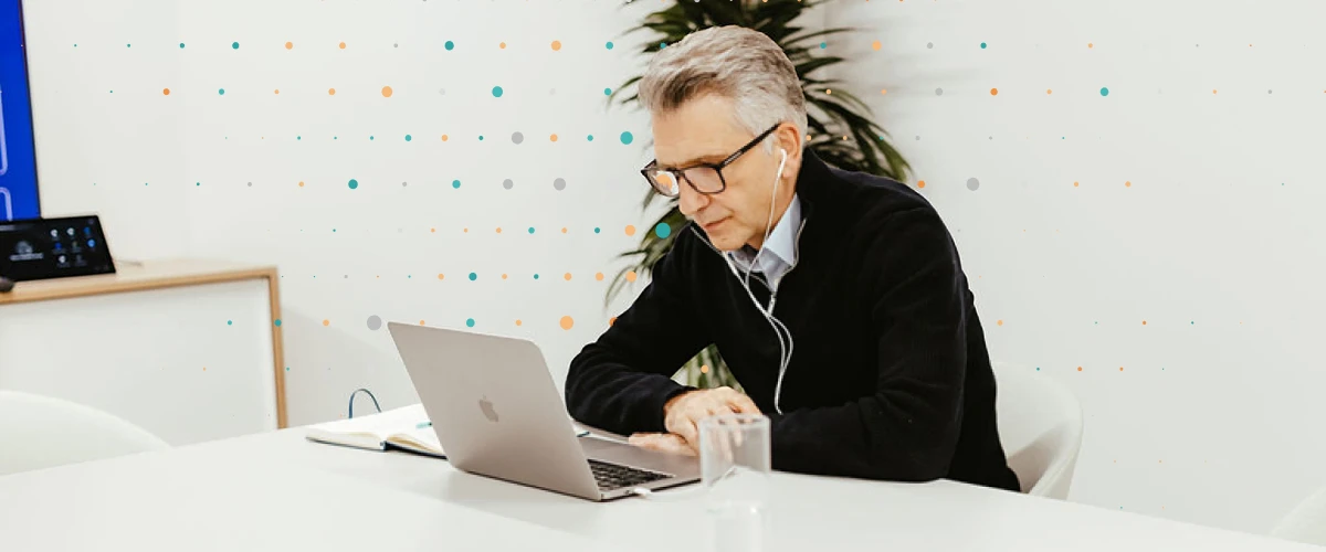 consultant looking at a laptop with headphones in