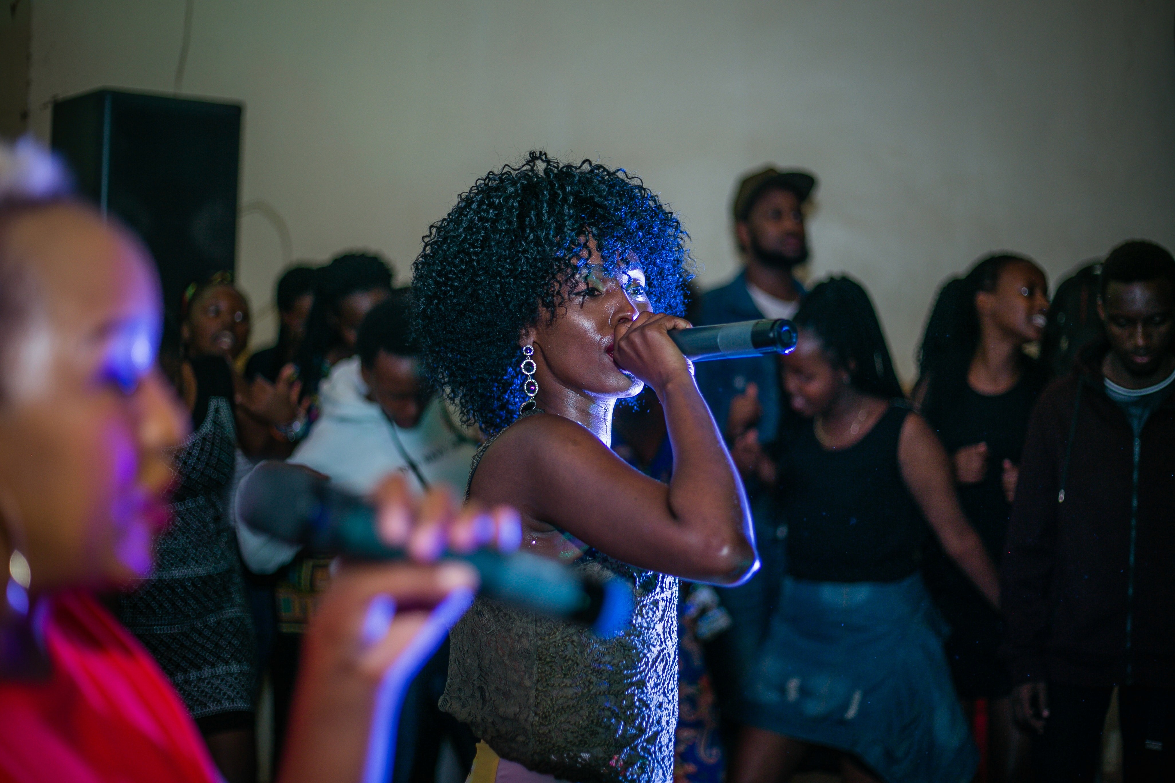 Woman singing in a social gathering - ai youngboy 2 songs