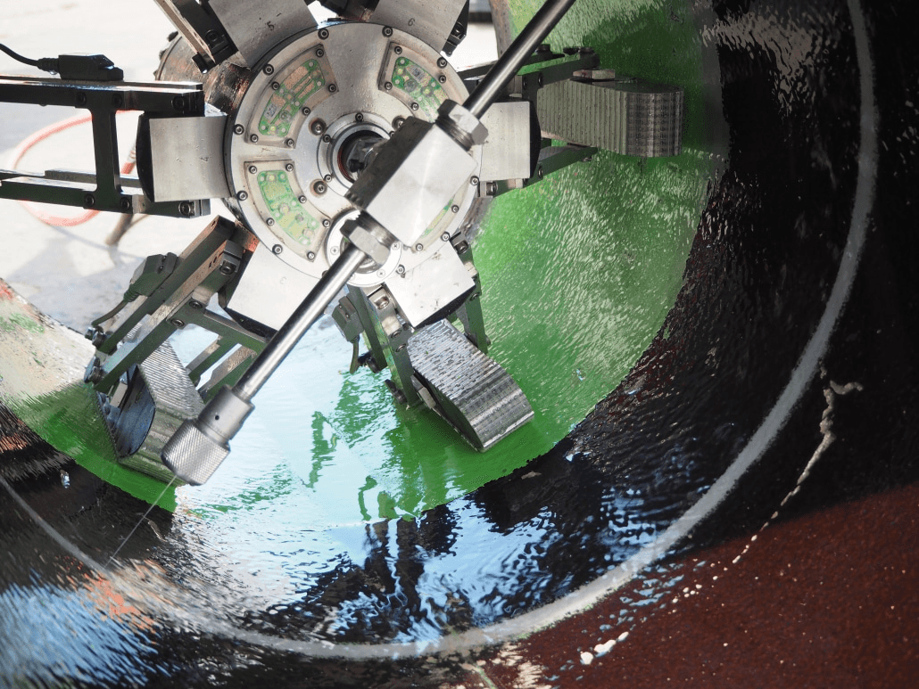 JettyRobot braced inside a large-diameter pipe with its wheeled centralizer arms