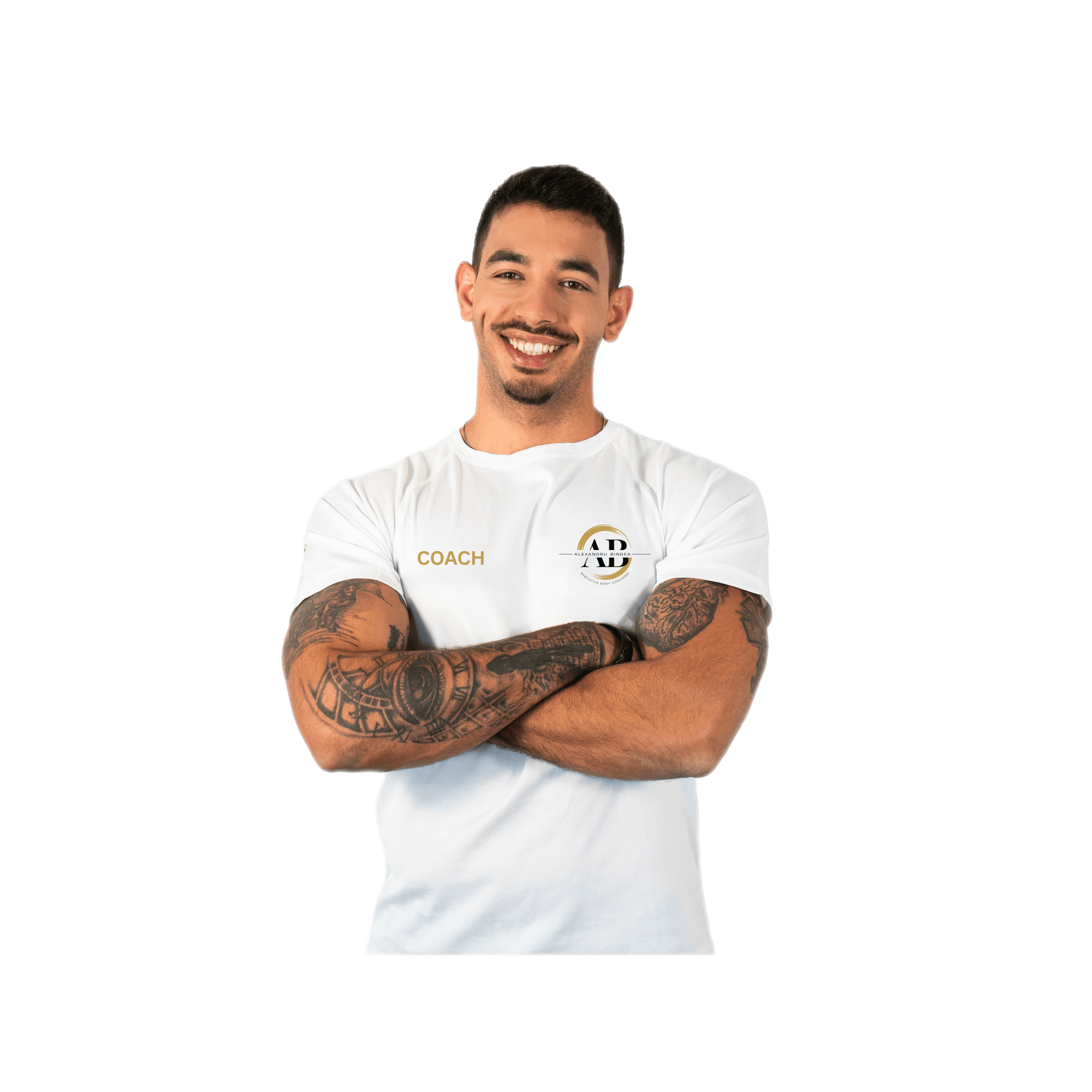 Smiling fitness coach with arms crossed, tattoos, and "Coach" shirt